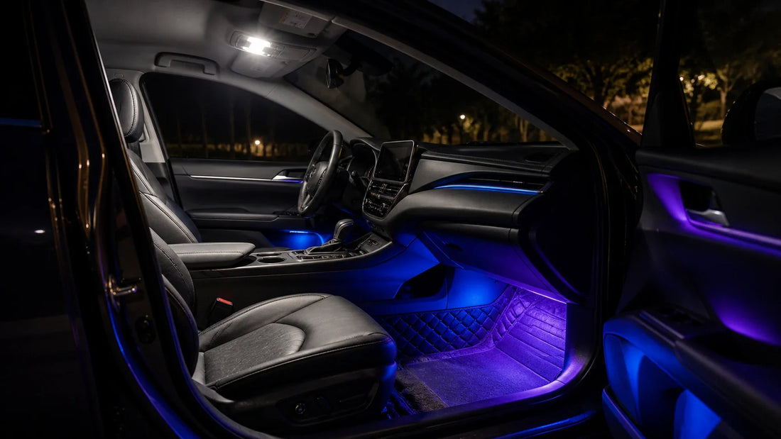 Parked car interior comparing a neutral white task light with soft blue and violet RGB ambient lighting in the cabin.