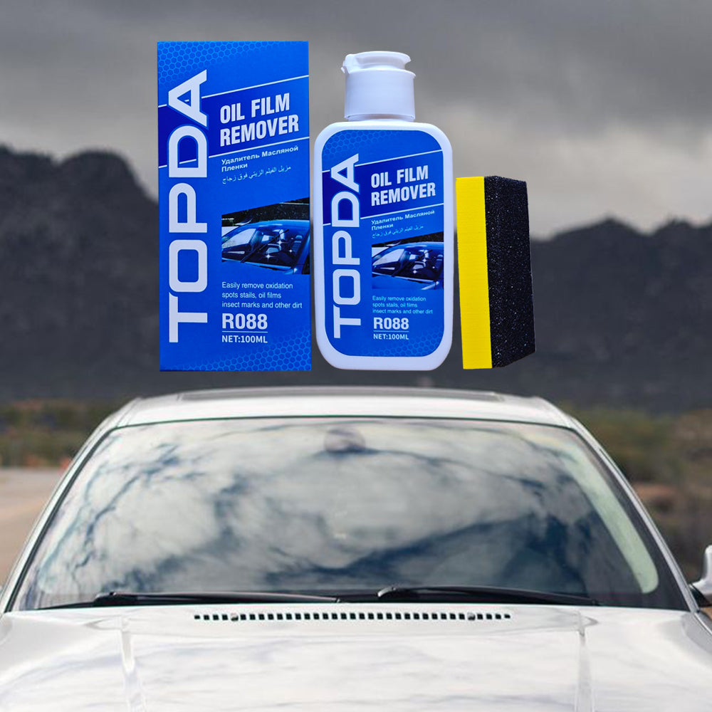Car glass oil film remover on a windshield for cleaning haze, traffic film, and glare-causing residue from auto glass.