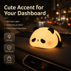 Cozy panda night light glowing on a parked car dashboard at night