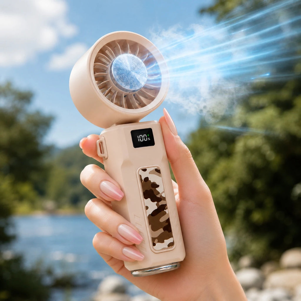 Close-up of beige folding handheld fan with icy airflow effect outdoors