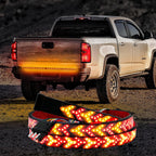 Pickup tailgate light bar installed across the rear of a truck for stronger brake and signal visibility after dark.