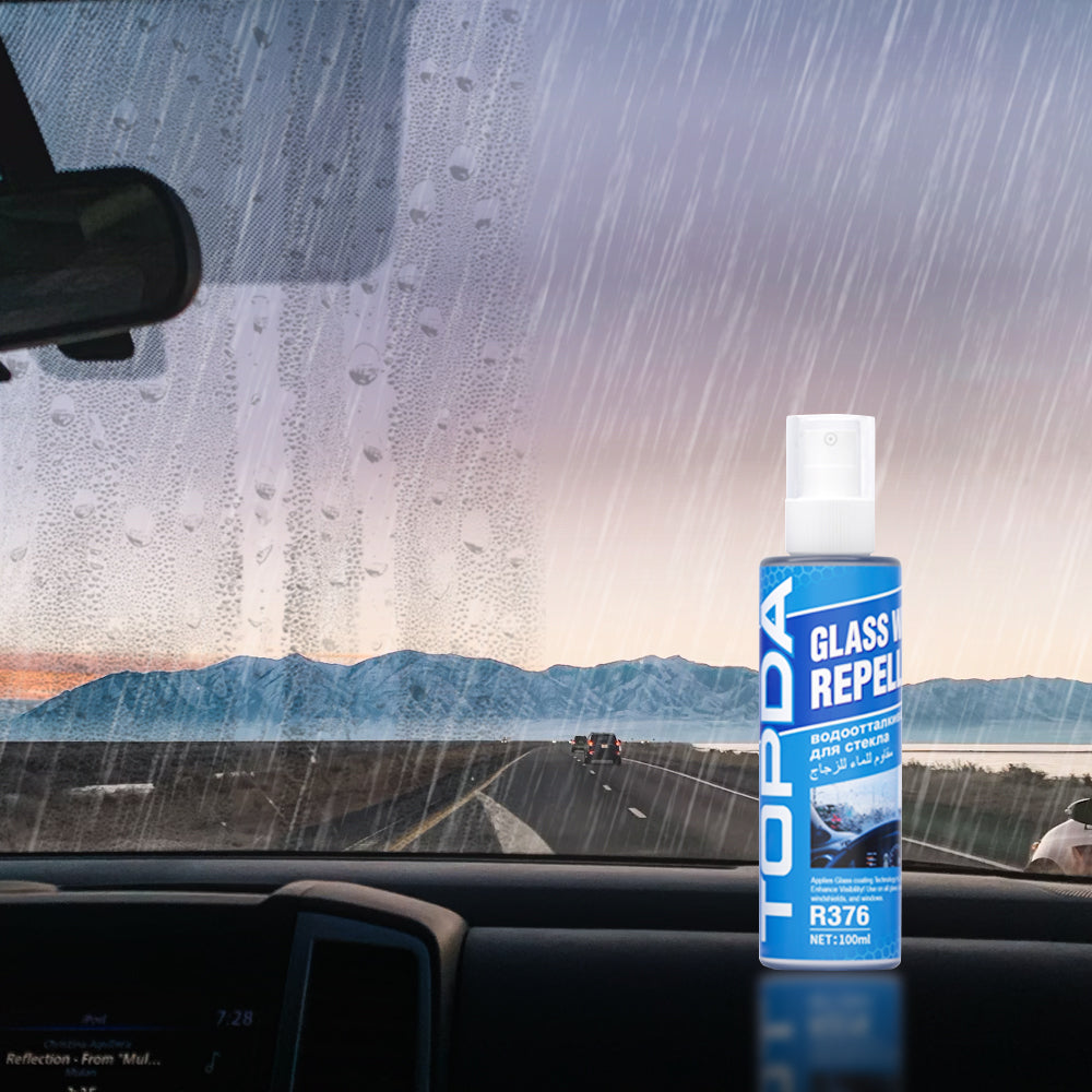 Car glass water repellent bottle inside a rainy windshield view for wet-weather windshield care.