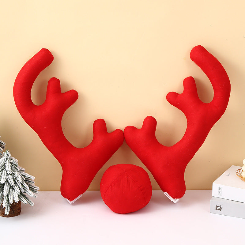 Red polka dot Christmas car antlers with Rudolph nose for playful holiday vehicle decoration.
