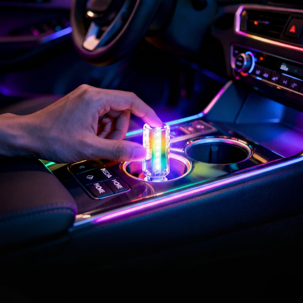 RGB USB mood light plugged into a car cup holder area for colorful cabin accent lighting during night drives.