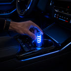 USB LED ambient lamp plugged into a car console creates a soft blue accent glow for night driving atmosphere.