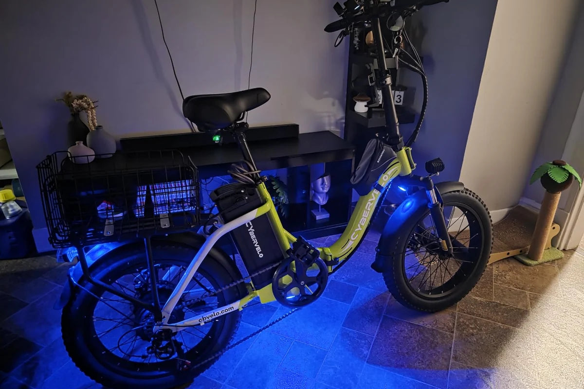 Blue LED accent lights placed around a bicycle frame and wheel area for a visible night setup.