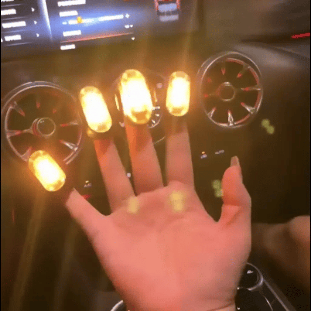 Wireless RGB footwell lights creating warm accent lighting around a car cabin