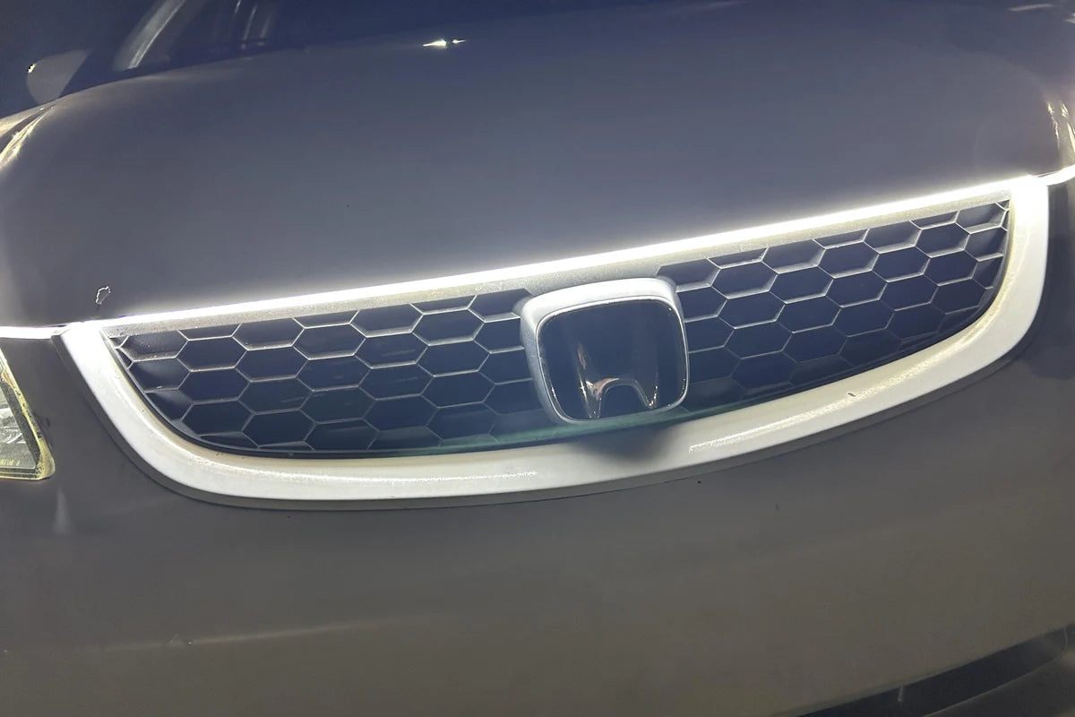 White hood LED strip installed above a honeycomb grille for a clean front-end accent.
